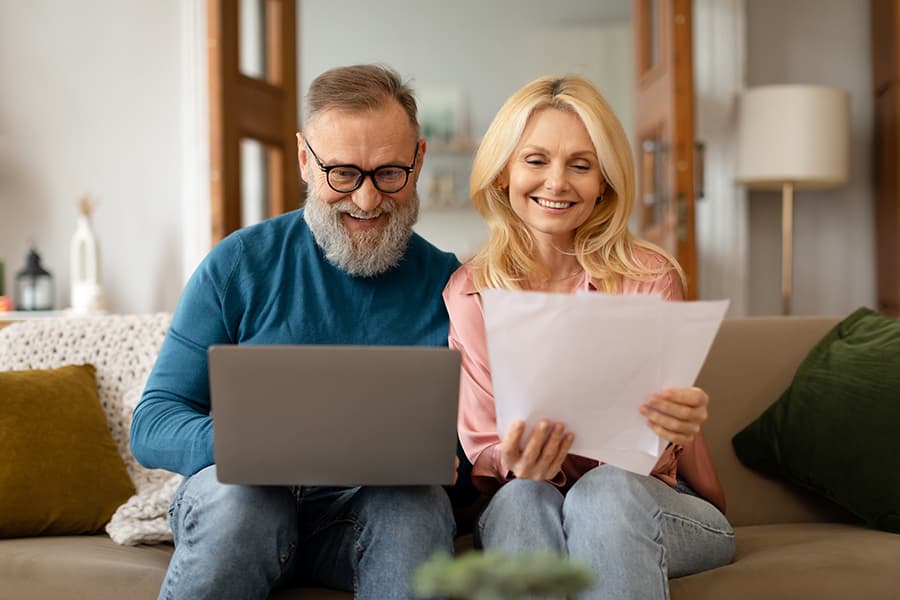 happy-mature-couple-doing-using-laptop-home-opt happy-mature-couple-doing-using-laptop-home